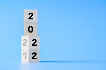 wooden cube block changing from New year 2021 to 2022 concept on isolated background with copy...