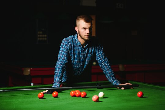 Young Handsome Man Leaning Over The Table While Playing Snooker