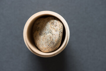 wooden object with pebble inside