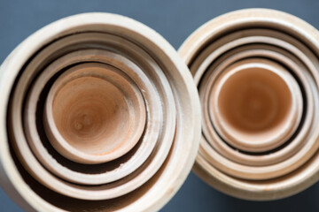 retro blank unpainted wooden nesting dolls or egg objects photographed from above with ambient...