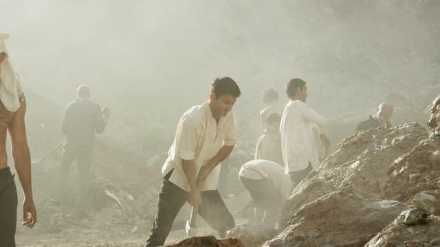 A group of miners or gold diggers are working . Many workers are mining with pickaxe in a quarry . Scenic shot in vintage style with artists . Shot on RED EPIC Cinema Camera in slow motion.