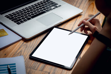 Closeup image of woman hand using computer and digital tablet with stylus pen on touch mockup blank...