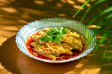 Salad with boiled chicken, cilantro, peanuts in hot soy sauce. Chinese cuisine.