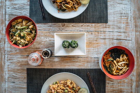 Tasty Asian food of sushi and noodles with chicken slices