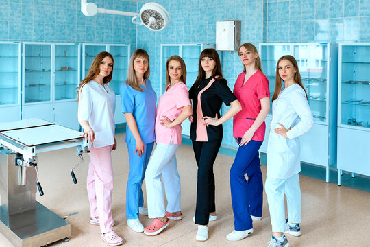 Medical students. Surgeons in the operating room. A group of young female doctors in colorful surgical suits. The concept of medical education. - Powered by Adobe