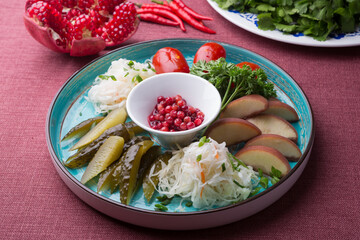 Different pickled vegetables sliced for snack on a plate