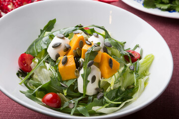 Fresh green vegetarian salad with pumpkin and seeds
