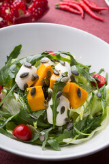 Fresh green vegetarian salad with pumpkin and seeds