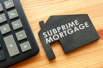 Subprime mortgage on the model of home and calculator.