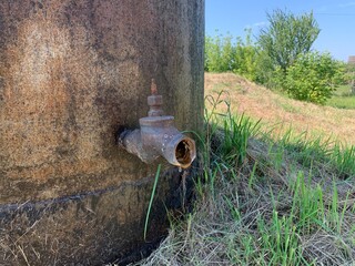 Rusty metal water faucet from the water tower.