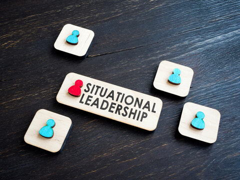 Situational leadership phrase and wooden figures.