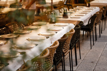 Served tables with white cloth in the restaurant outdoors
