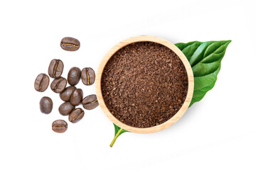 Roasted coffee beans and coffee powder (ground coffe) in wooden bowl with green leaf isolated on...