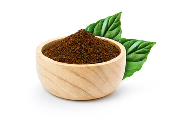 instant granulated coffee powder in wooden bowl and green leaves isolated on white background.