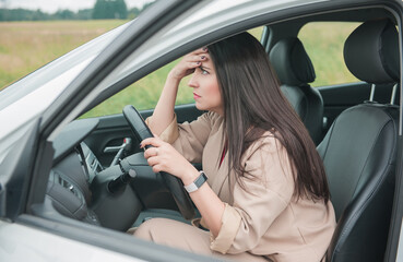 Obraz na płótnie Canvas Sad woman driver sitting inside the car