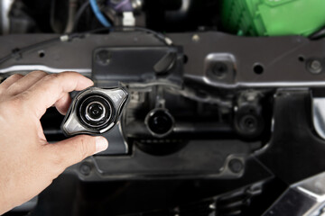Hand a man open the Radiator cap of engine for check level of water Car radiator basic checking on car service concept