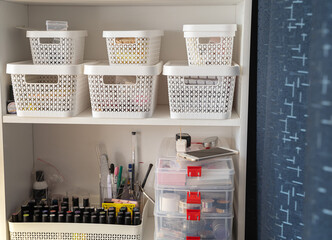 Two shelves with accessories and tools for manicure. Beauty salon, nail care, nail master's office.