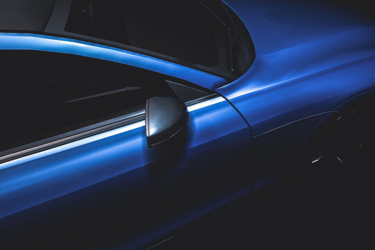 modern blue luxuary car side view under spotlight