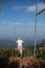 Woman is swinging on a swing in Mon Jam