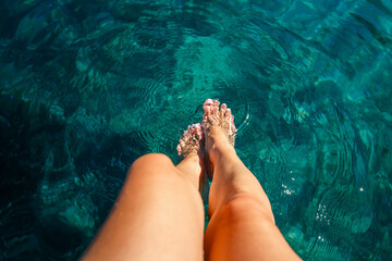 Closeup on beautiful sexy women's feet on the yacht, carefree vacation, journey on sailboat, happy and healthy lifestyle, pleasure concept