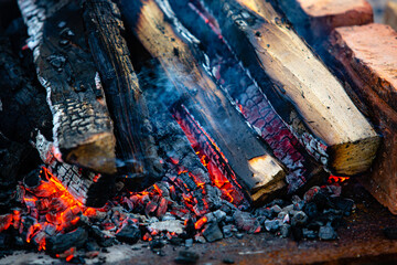 Close-up firewood, hot coals and ash. Lighting barbecue coals.
