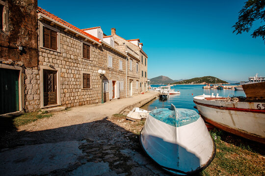 An old abandoned wooden boat off the coast of an island in Croatia. View of the fishing village