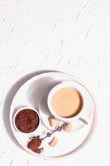 Morning cup of coffee. Ground powder, brown sugar, stand