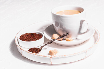 Morning cup of coffee. Ground powder, brown sugar, stand