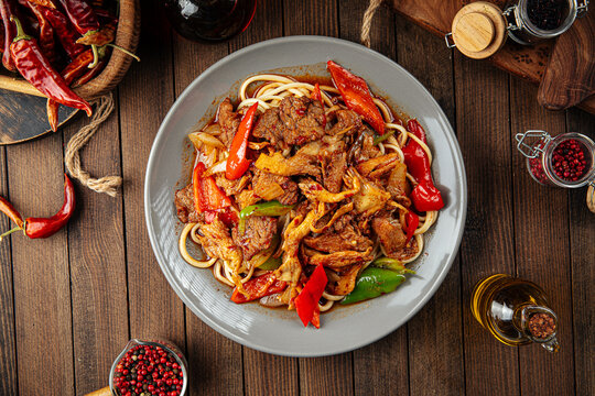Asian uyghur dish guiru lagman noodles on a wooden background