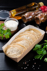 Ukrainian food. Dumplings, Vareniki in paper plate for delivery. Street food concept.