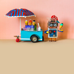 Ice cream shop and robot seller. A funny smiling robotics shopman with ice cream. Summer time,...