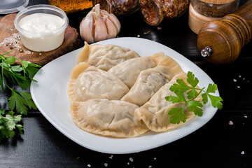 Top view fresh hot dumplings on plate. Chinese dish on rustic old vintage wooden background.
