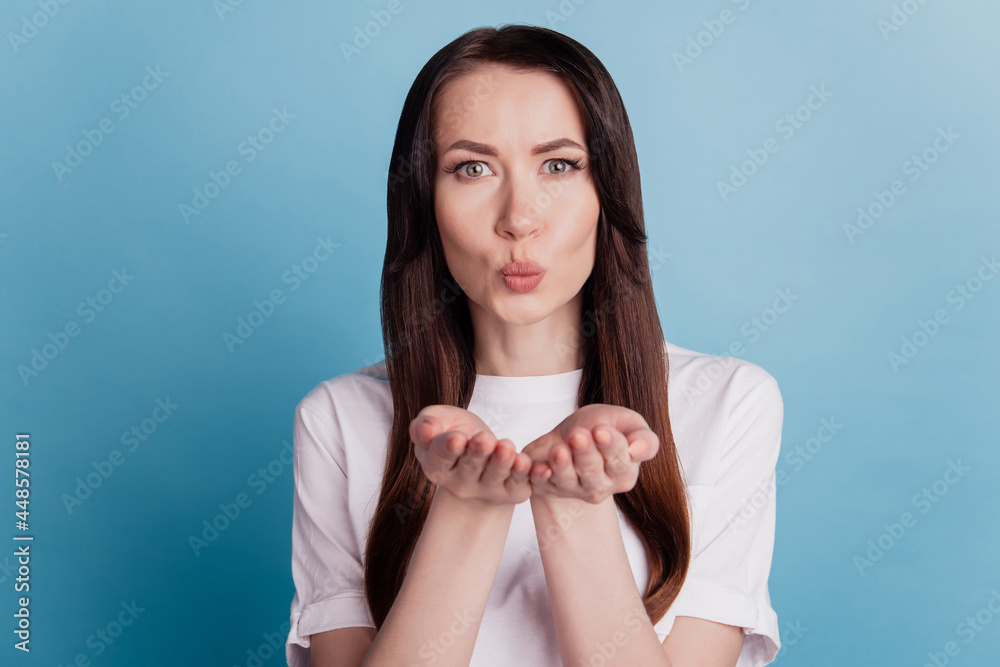 Wall mural portrait of lovely lady air kissing you isolated over blue background