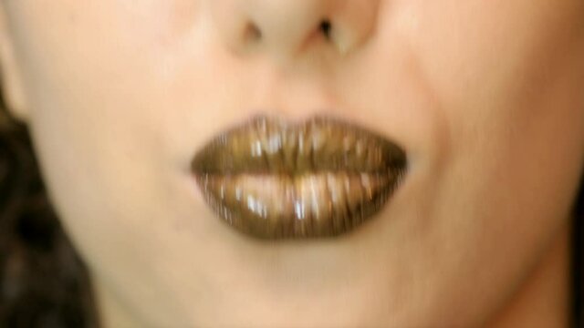 Closeup of a beautiful woman lips with beautiful chocolate makeup sending air kiss . Close up of girl's mouth having flirty emotions and sending air kiss .
