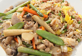 chinese chicken vegetable stir fry with ham fried rice served on plate
