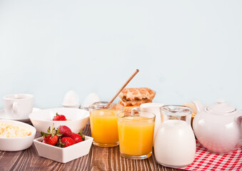 Cup of coffee, juice, eggs, fruits, toasts. Breakfast concept.