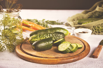 Pickled marinated cucumbers in a kitchen table with dill, spices and garlic