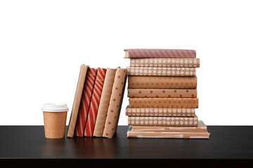 Books on black table against white background