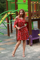 Woman in red dress in the playground