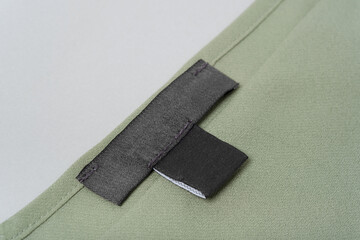 mockup black Blank label on a green khaki blouse close-up
