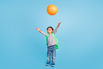 Full length body size view of nice cheerful boy throwing air ball celebrating isolated over bright blue color background