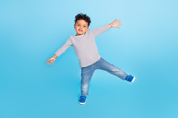 Fototapeta na wymiar Full length body size view of nice cheery boy dancing having fun isolated over bright blue color background