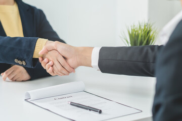 Successful asian young woman, man partnership, teamwork handshake or greeting together at office after project done, good deal. Happy business people, worker or group meeting, shaking hands concept.