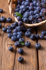 Blueberries in basket on wooden table