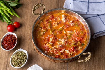 Famous Turkish menemen dinner on table, made by eggs, pepper and tomatoes.