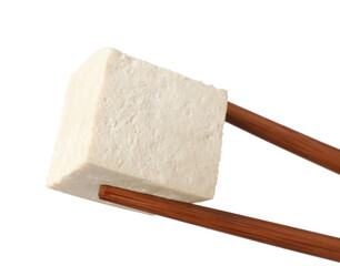 Chopsticks with delicious raw tofu cube isolated on white