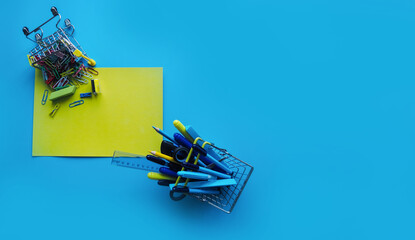 School supplies and office supplies on a blue background. Yellow sheet of paper. Preparation for school. Education concept. Place for your text.