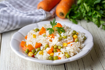 Delicious vegetable rice pilaf with green peas, carrots and sweet corn