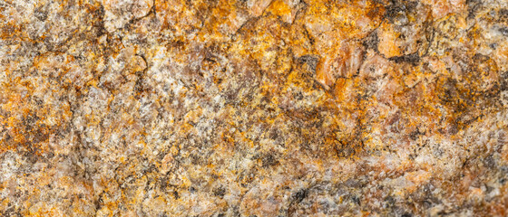 Background of granite. Texture of brown granite stone. Weathered stone surface. Copy space