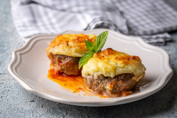 Turkish Food Hasanpasa Kofte - Kofta with Puree - Meatball with Bechamel Sauce and Green Peas. Traditional Food.